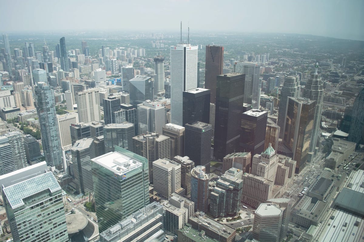 Aerial view of Toronto's modern skyline featuring towering skyscrapers and the urban landscape.
